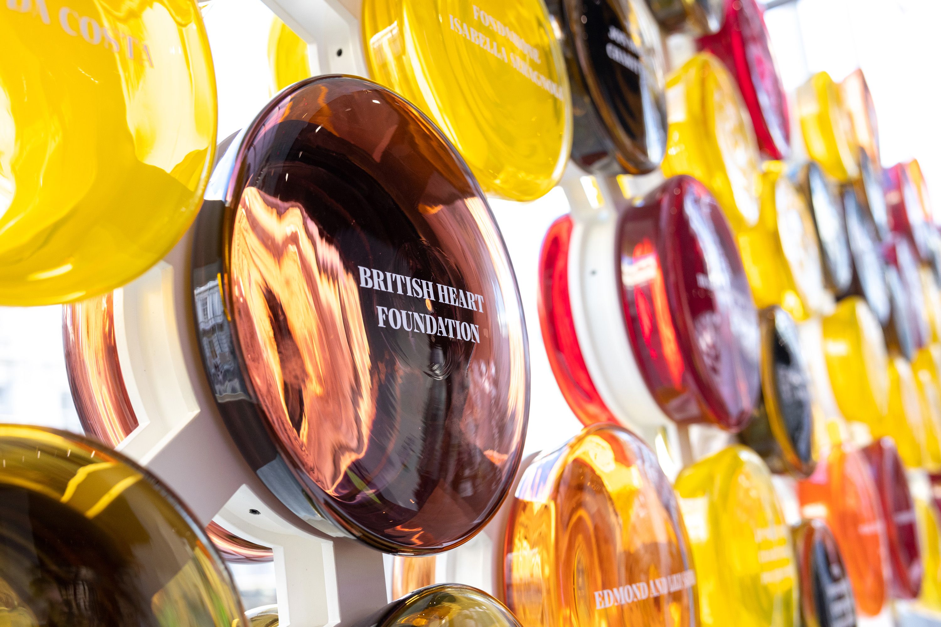 The Circle of Benefactors exhibition in the College's Main Entrance, which consists of circles of coloured glass with the names of donors printed on