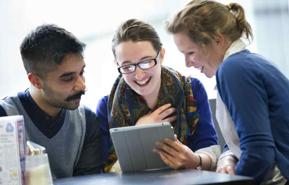 Students using an iPad on campus