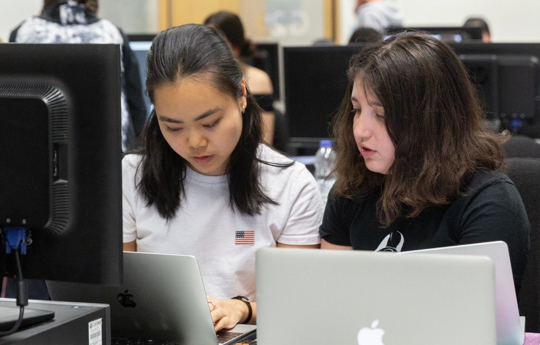 two students studying in the library