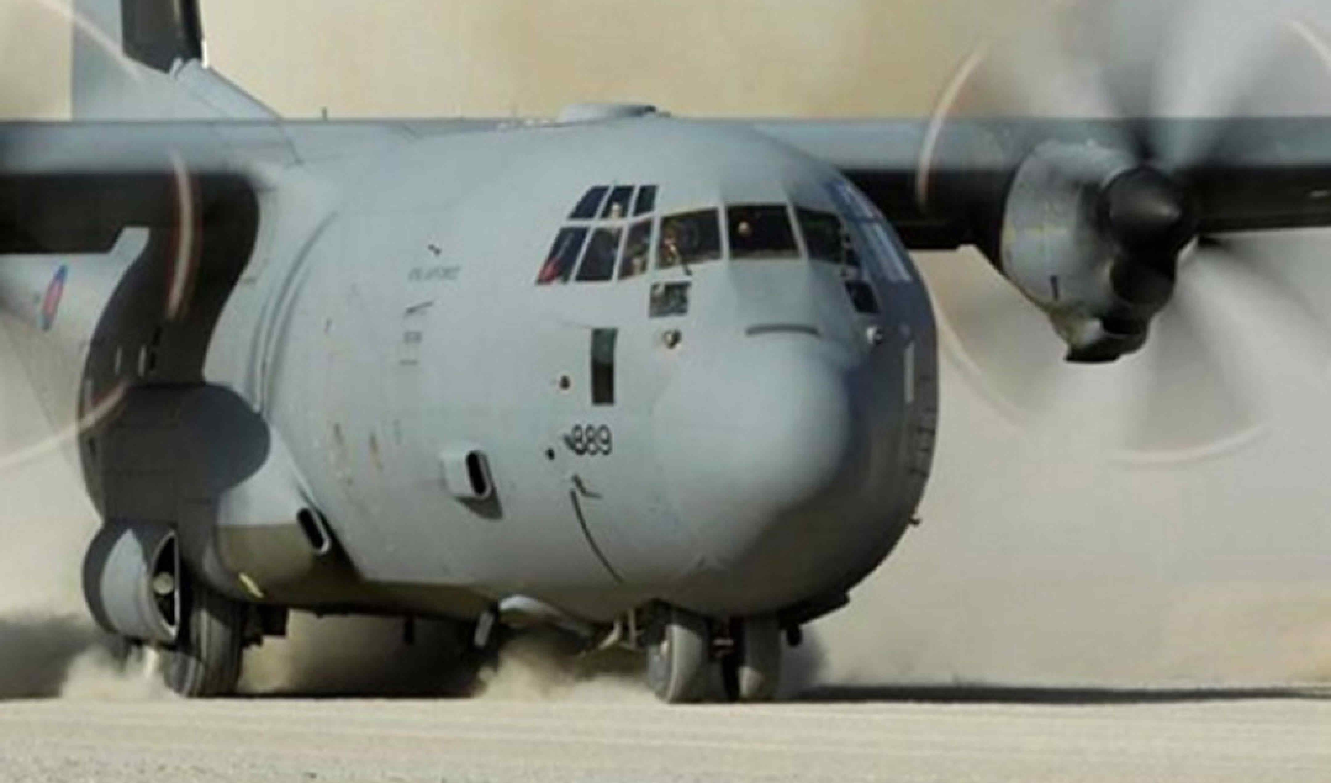 Hercules plane landing on gravel