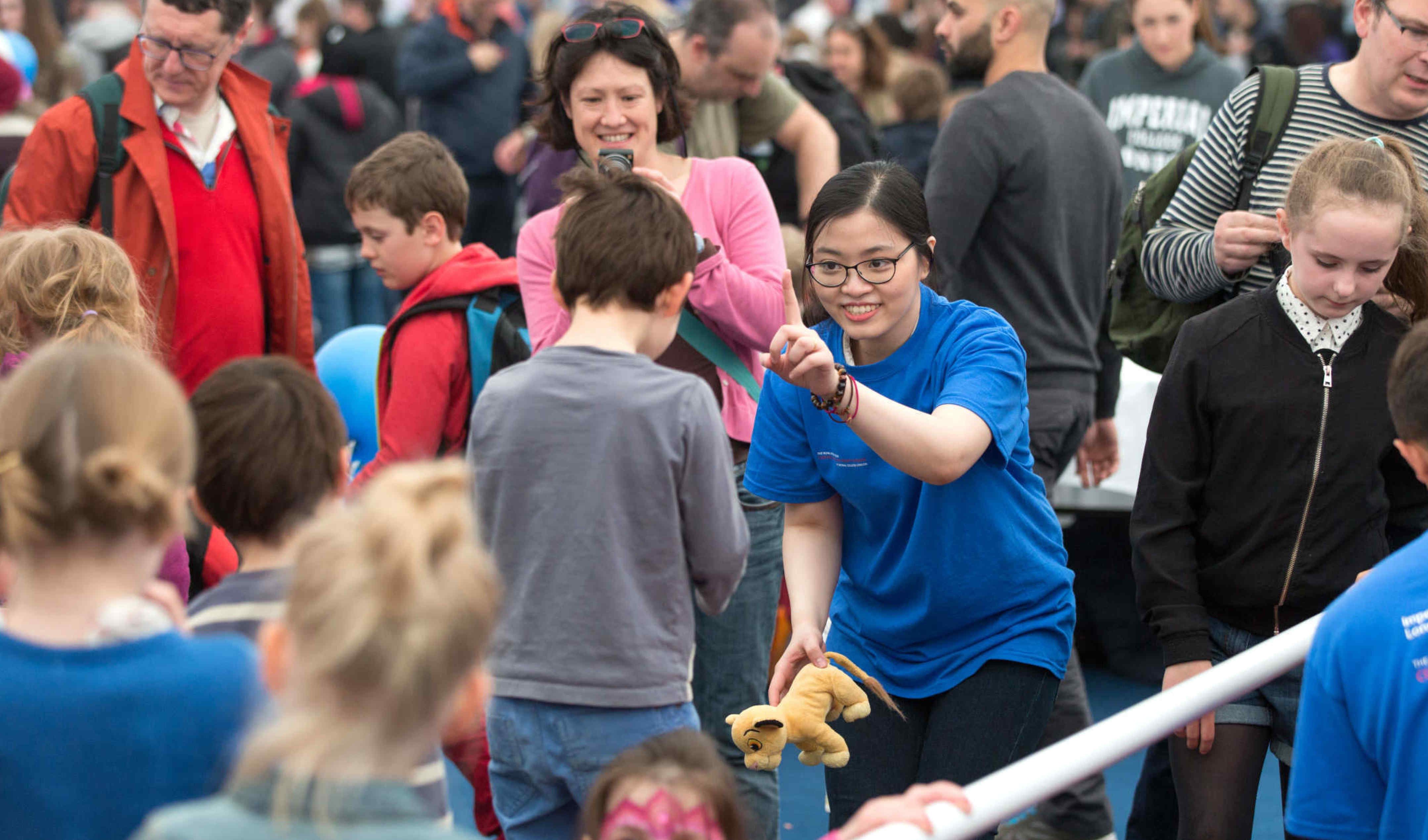 A research staff member interacting with guests at the 2017 Imperial Festival.