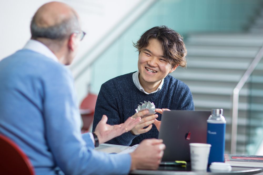 Mechanical engineering student talking with staff member