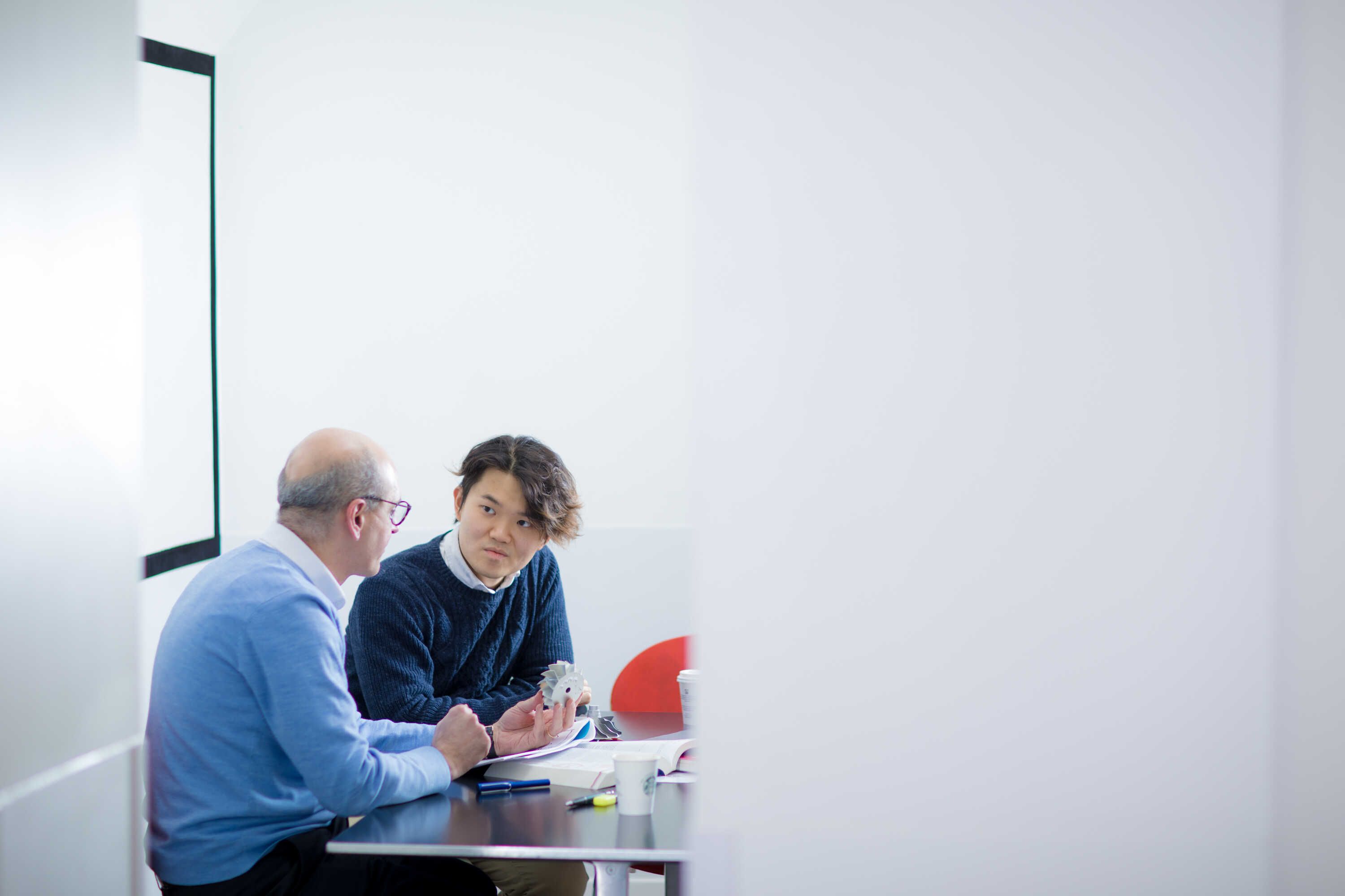 A student speaking to his tutor