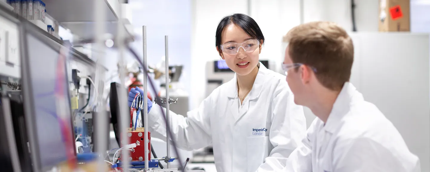 Woman demonstrating something to a man in a lab