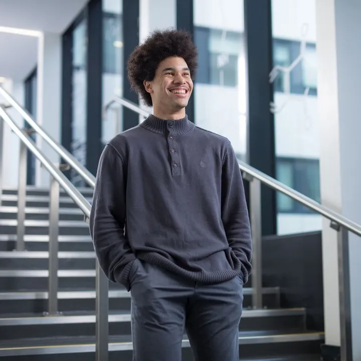 Smiling student walking down steps