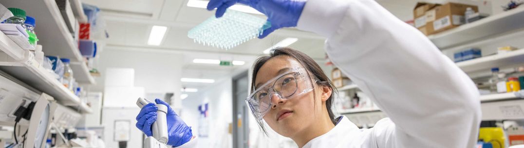 A student examines samples in the lab