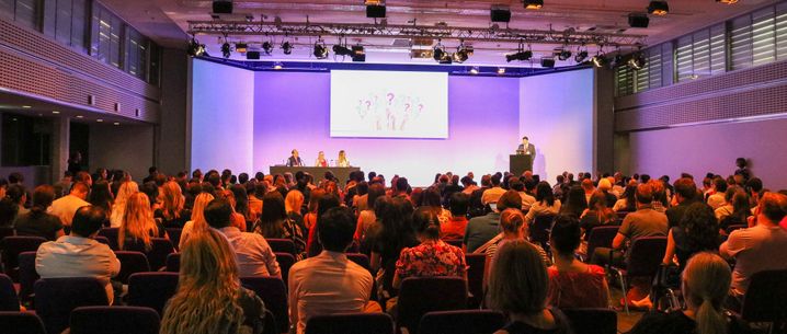 audience look at screen in lecture theatre