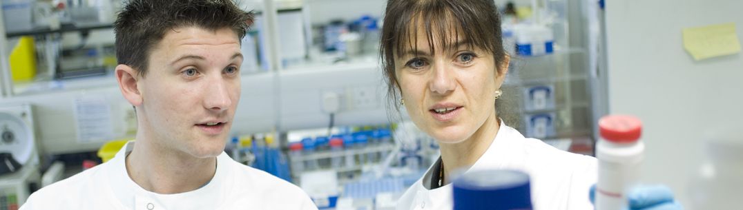 Dr Sarah Fidler and research colleague in a research lab