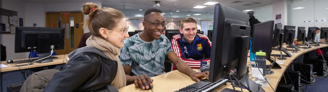 students looking at a laptop screen