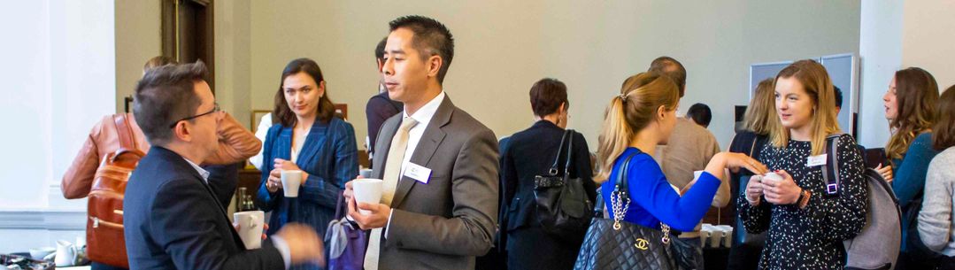 Scientists and research professionals engaged in conversation at an event