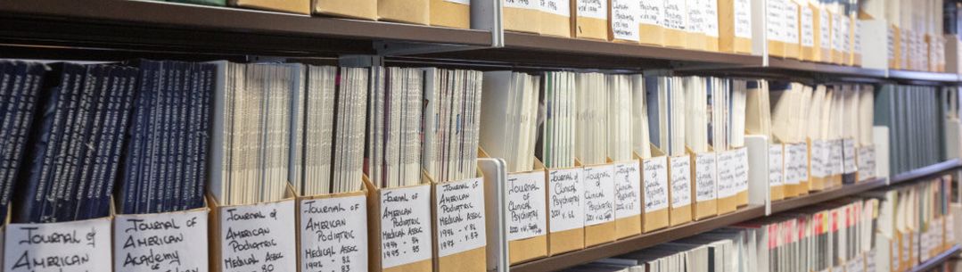 shelves of boxes containing print journals