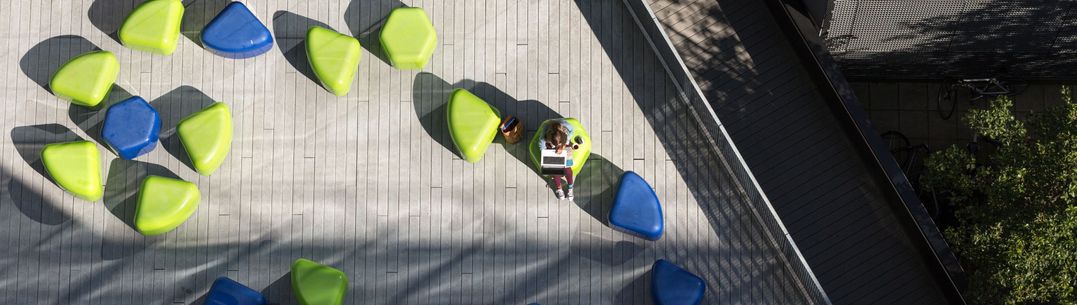 Aerial view of Dalby Court with a student sitting on the coloured blocks