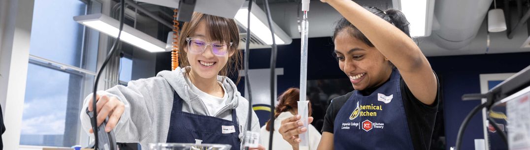 Two students use lab equipment to make yoghurt in the Chemical Kitchen