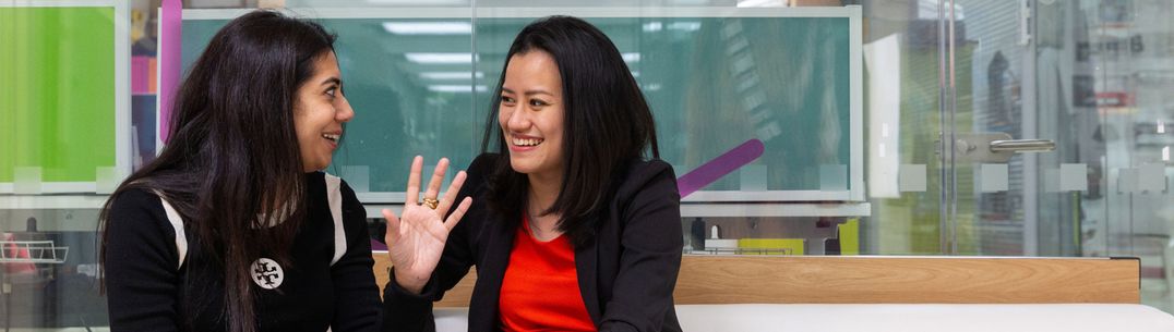 Pae Natwilai, founder of Trik drone mapping software sits with a student she is mentoring, they are both talking