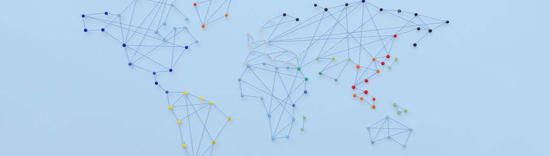 A graphic showing a simple world map connected by string and pins