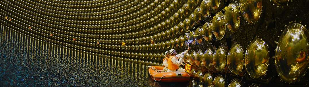 Two academics work on the neutrino detector