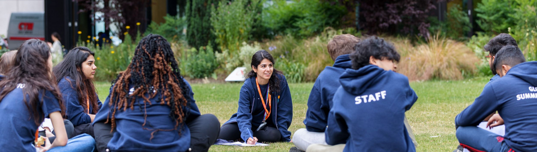 GSS mentors sit on grass