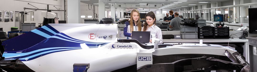 Two students work on a racing car