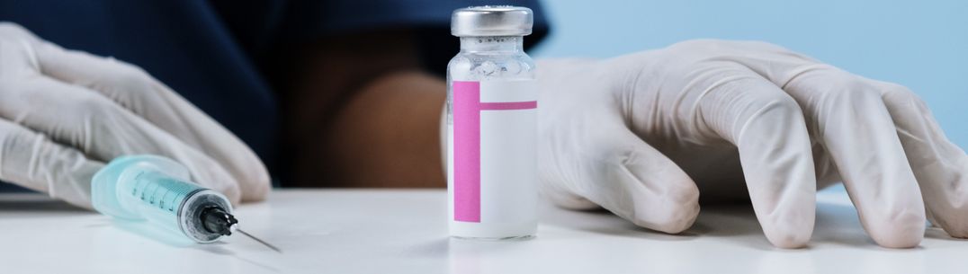 A picture of a vaccine vial and a hyperdermic needle. Photo by Cotton Bro Studio