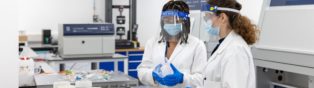 Two female students in a lab researching plastic pollution