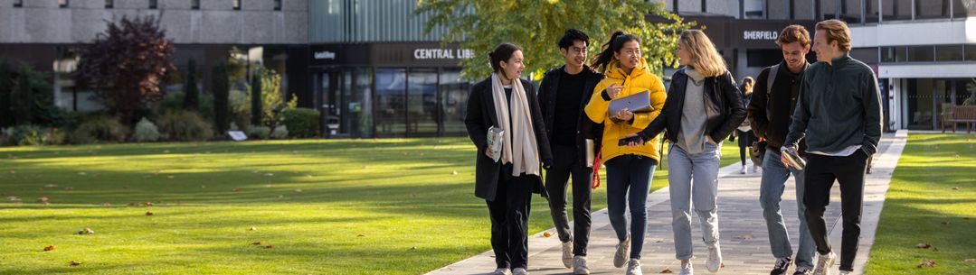 students walking along the queen's lawn path