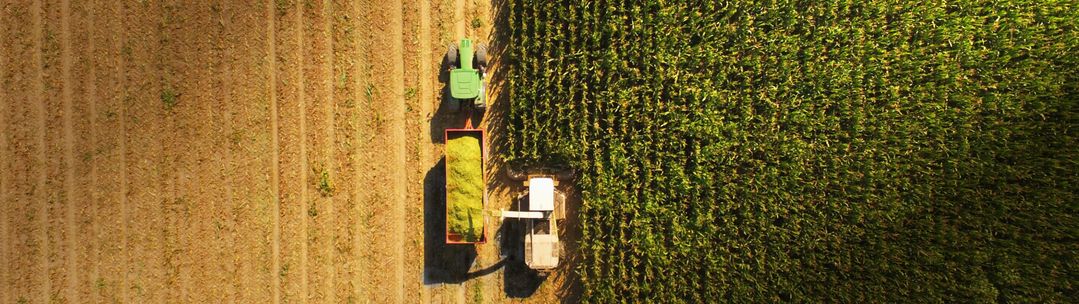 Aerial view of tractor harvesting crops
