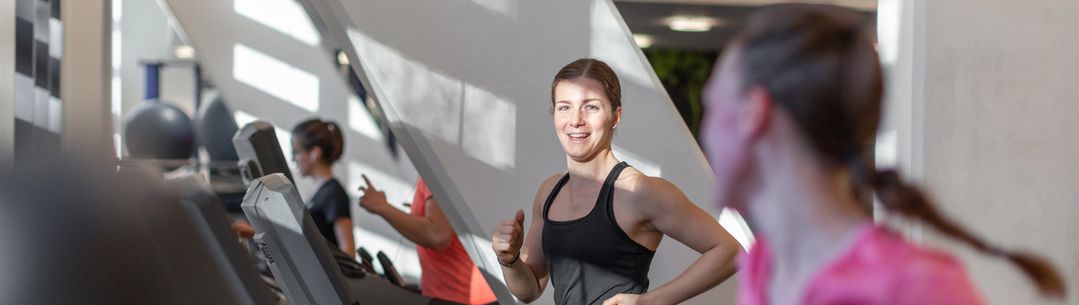 Two people on treadmills