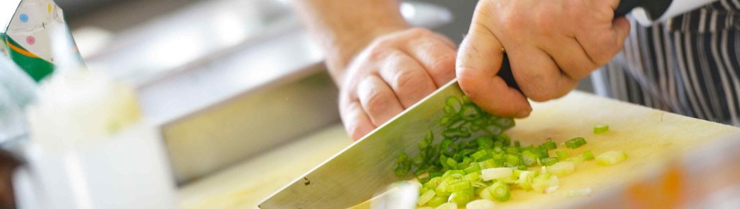 Chef cutting on chopping board