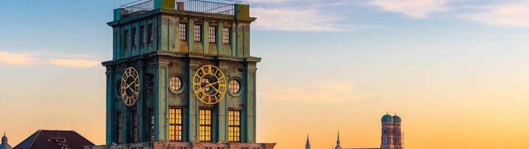 A clock tower with sunset sky