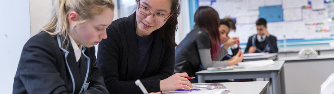 A Pimlico Connection tutor helps a secondary school student with her work.