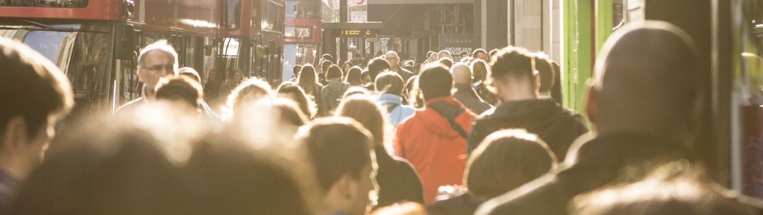 A crowd of people walking through London