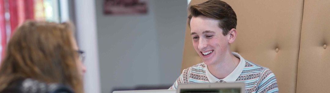 Student smiling with laptop