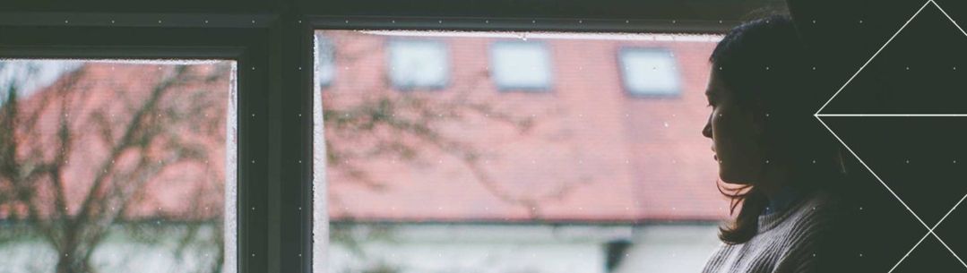 Woman looking outside a window