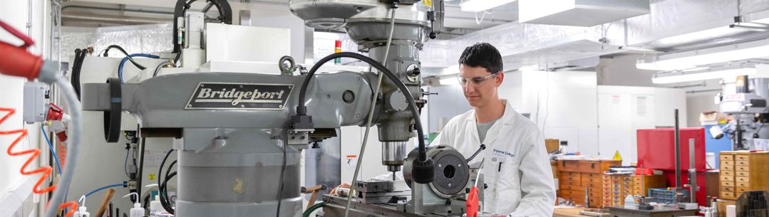 Apprentice using machinery