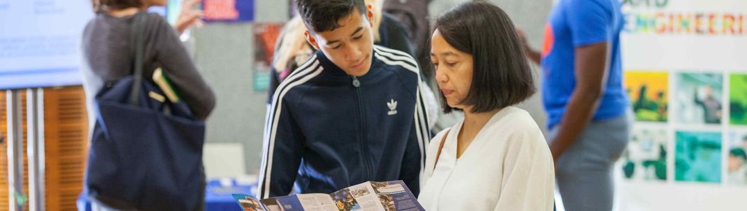 Parent and child looking at prospectus