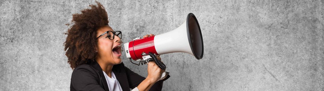 Woman shouting through a loud speaker