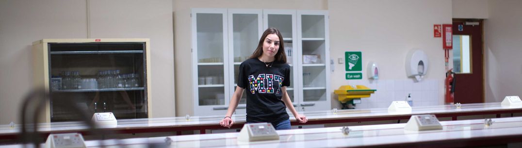 Student in MIT shirt in lab