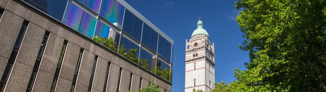 south ken tower reflected in library building