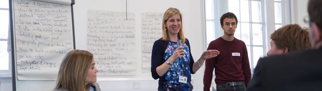 female tutor speaking to a group of students