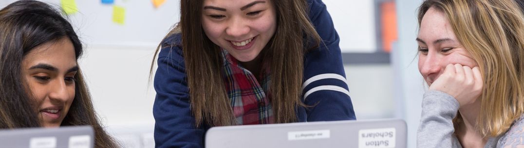 people gathered around a computer