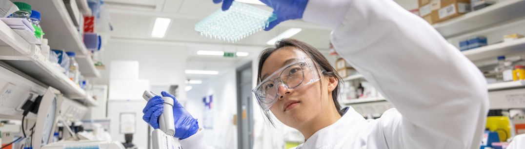 student lifting an experiment in the lab