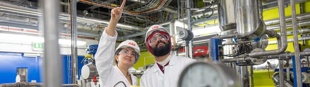 Two Chemical Engineering undergraduates wearing PPE in the Carbon capture plant