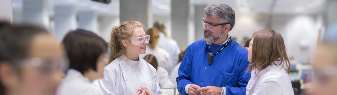 Professor teaching students in a laboratory