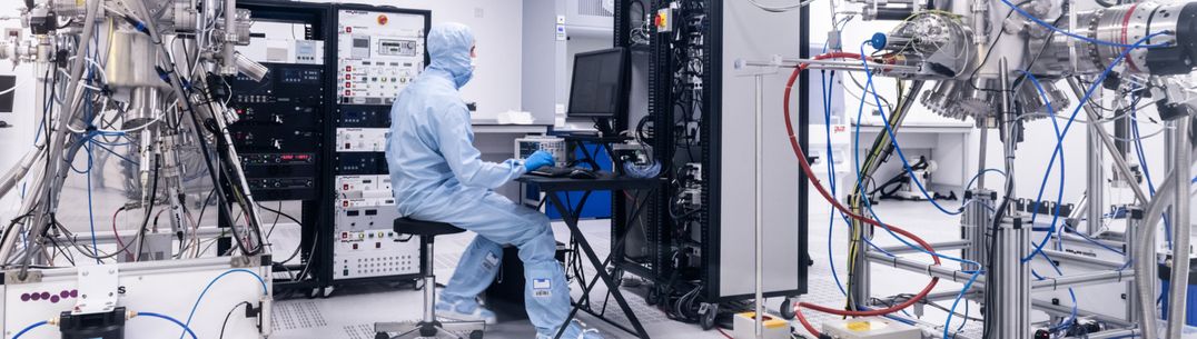 Person wearing a boiler suit in a lab