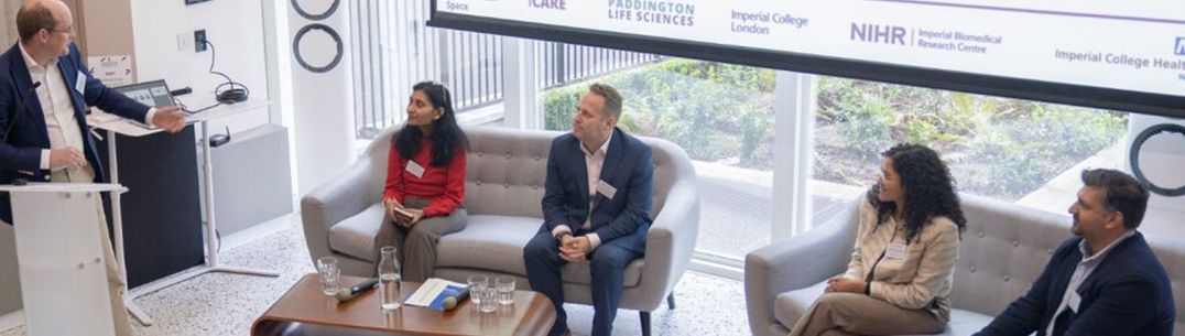 A photo of a panel of people speaking at a conference