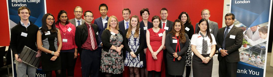 A diverse group of young people lined up for a formal photograph between banners reading Imperial College London and Thank you