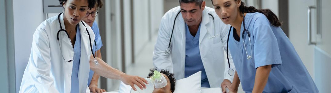 An image of nurses and doctors moving a patient