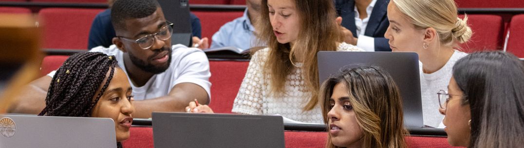 students in a teaching space with laptops