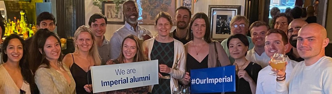 group of alumni in pub holding banners which say Our Imperial and Imperial Alumni