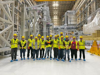 Students standing inside nuclear fusion reactor experiment construction